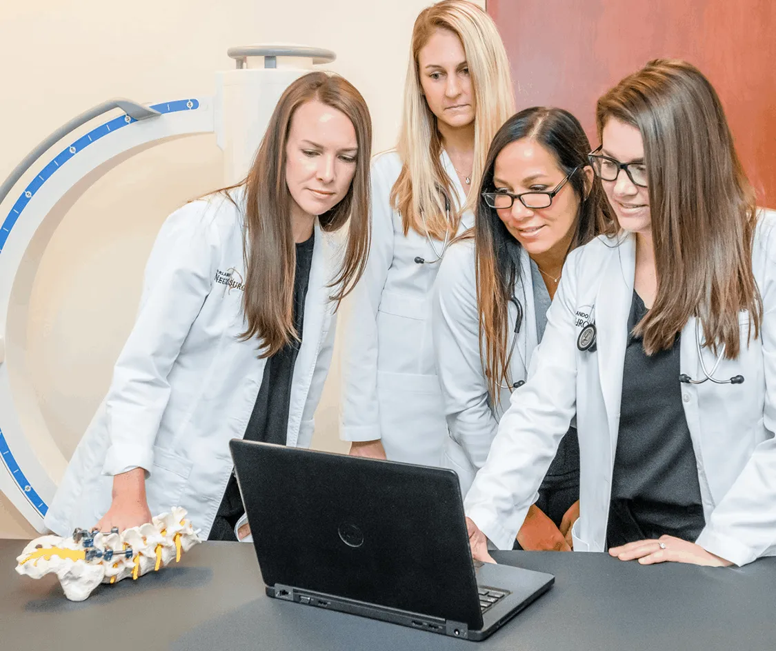 Women collaborating on laptop in office